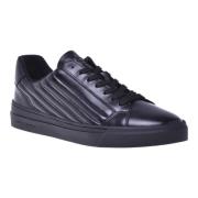 Trainers in black quilted leather and leather